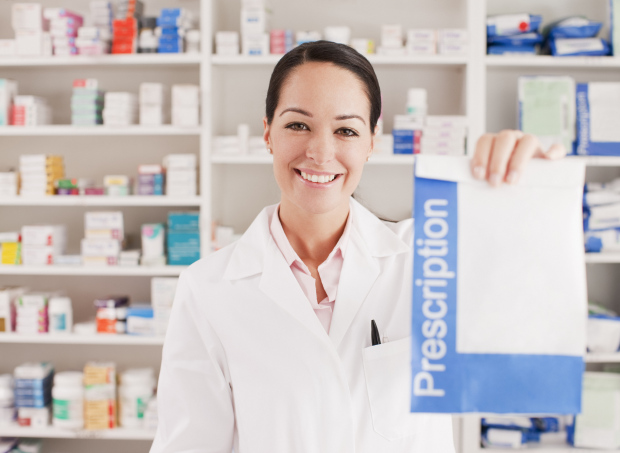 Pharmacist holding prescription in drug store