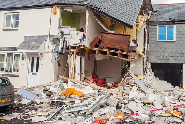 A 68-year-old man has miraculously survived an explosion at his house in Trecalgo View, Camelford, Cornwall, after an explosion blew out the walls sending debris flying into nearby homes and cars. 02/09/2015  See SWNS story SWGAS: A 68-year-old man has miraculously survived after an explosion at his house in Cornwall blew out the walls sending debris flying into nearby homes and cars. The emergency services were called to the terraced house in Trecalgo View, Camelford, at 11.30pm last night after the explosion was heard across the town. The man has been named locally as Bob Moss. Devon and Cornwall Police said: “One house had been badly damaged with the external walls blown out the internal walls badly weakened leaving the top floor and roof substantially unsupported.