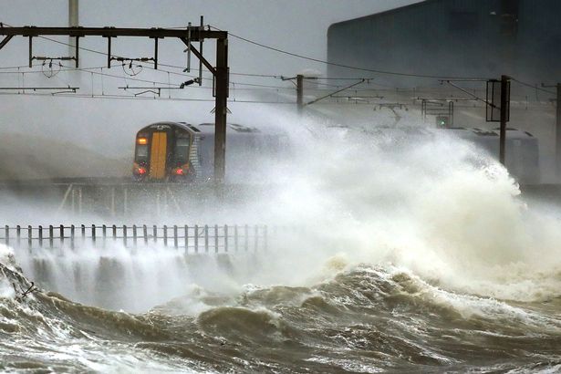 a-train-passes-through-the-coast-at-saltcoats-in-scotland