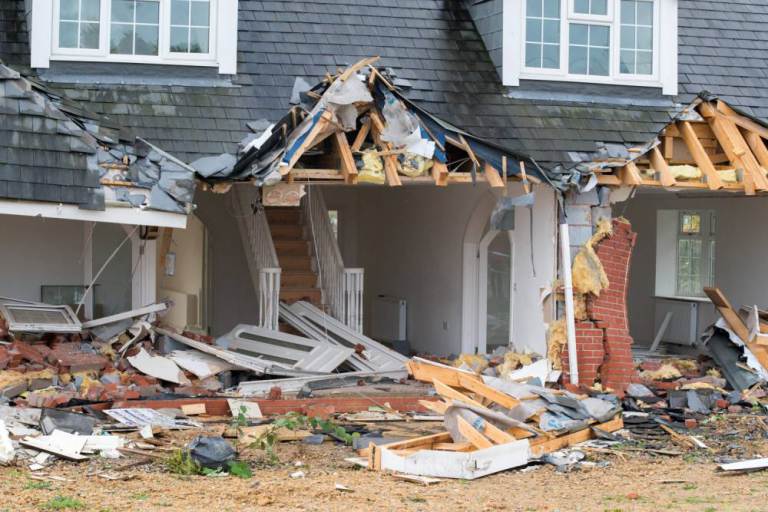 The damaged house on Tewkesbury Rd in Cheltenham. Half of a house has been demolished after a lorry apparently rammed into it repeatedly in what looks like a deliberate offence. See swns story SWWRECK.  The entire brick wall at the front of the driveway has collapsed and the whole front section of the house in Cheltenham, Gloucestershire has been destroyed. The police  have cordoned off the scene and are investigating.