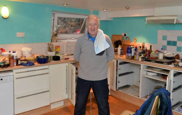 Peter Clarkson from Kendal Swiming in his Flooded House nPix Dave Nelson
