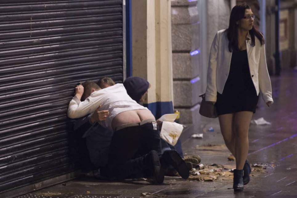 Revellers out in Cardiff, South Wales, celebrating New Year's Eve. Police increased patrols in the city centre in an attempt to crack down on alcohol-related disorder. Picture shows a man with his trousers down on St. Mary's Street, Cardiff. PIC Matthew Horwood © WALES NEWS SERVICE