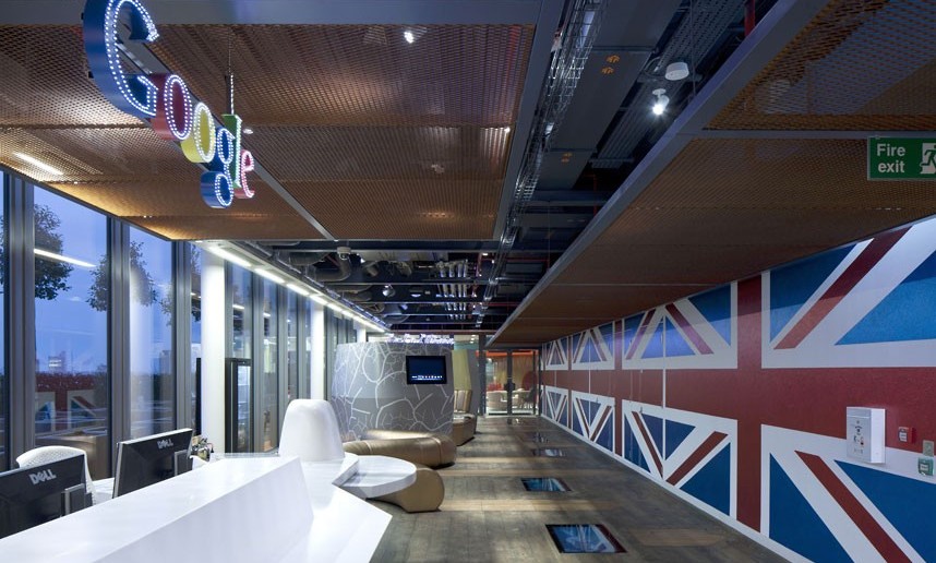 Google headquarters, Central Saint Giles, Covent Garden, London, Britain - 06 Aug 2012...Must credit PENSON/Rex Features Mandatory Credit: Photo by PENSON / Rex Features (1811356a) A Peek Inside Google's London Headquarters It features a secret garden, 'Granny flat' interiors and an allotment - welcome to Google's new London headquarters. The 160,000 sq ft hub features cutting-edge design that offers a quirky take on the traditional office. Occupying half of the ultra-modern Central Saint Giles development in Covent Garden over five floors, renowned interior designers PENSON were given the task of creating a vibrant workspace. The result is amazing variation of work and lounging space which finds room for 1,250 non-traditional desks. A space called Granny's Flat is furnished with chintzy chairs and fittings that wouldn't look out of place in an elderly relative's lounge, while the Lala Library hosts a giant semi-circle white sofa adorned with pillows and surrounded by arty and inspirational books. Surreal workspaces have tongue-in-cheek names such as the Velourmptious snug, a green, padded homage to the traditional British pub, and Snug-lushness, a garish flower-print padded bench seat. An area dubbed the Town Hall allows seating for 200 people and features velvet curtains, exposed ceilings and a video wall, while the Market Square is a rustic cafeteria area. For active staff members there is a gym and dance studio, a 'bikedry' for cycling gear storage and a shower block for those sweaty from the morning workout, cycle or commute. For those really wanting to escape the office, a 'Hedge Your Bets' secret garden on the roof terrace affords stunning views of London surrounded by grass and foliage - all with wi-fi connection for laptop work. Eco considerations are at the forefront of design with a high content of reclaimed or recycled materials employed and the use of water-based products and timber floor boards with Eco plywood perimeter